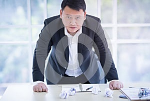 Asian Businessman disappointed with the job project in office.