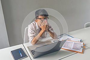 Asian businessman feel headache, tired and exhausted in the business room