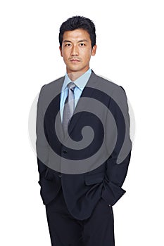 Asian businessman, hands and pocket standing in confidence against a white studio background. Portrait of a isolated