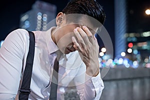 Asian businessman has headache