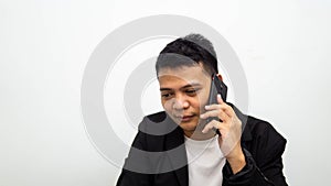Asian businessman having a serious talk and conversation on the phone