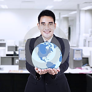 Asian businessman holding globe