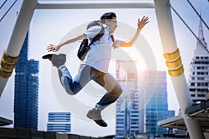 Asian businessman jumping with building and cityscape background