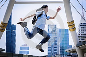 Asian businessman jumping with building and cityscape background