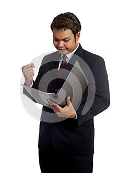 Asian businessman look at report and hold his fist with success