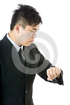 Asian businessman looking at watch
