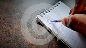Asian businessman making notes on daily strategy or goals