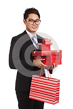 Asian businessman with many gift boxes and shopping bag