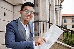 Asian businessman with paper in the street