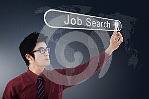 Asian businessman pressing a job search button