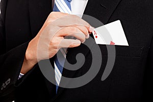 Asian businessman pull playing cards from pocket