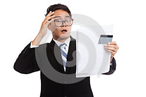 Asian businessman shock with a credit card and statement
