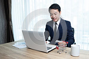 An Asian businessman shopping online