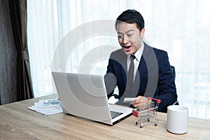 An Asian businessman shopping online