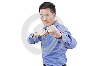 Asian businessman showing karate move