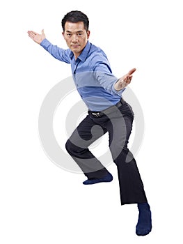 Asian businessman showing karate move