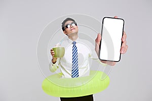 Asian businessman showing smartphone mockup of blank screen booking check-in going to travel on summer holidays