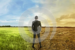 Asian businessman standing between different climate