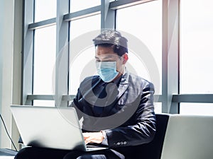 Asian businessman in suit wearing protective face mask