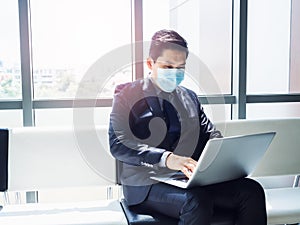 Asian businessman in suit wearing protective face mask