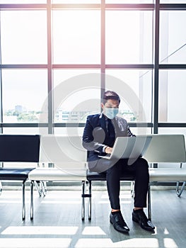 Asian businessman in suit wearing protective face mask