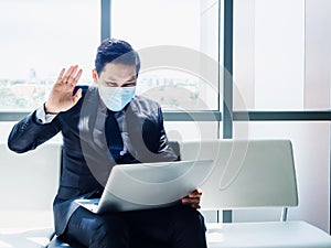 Asian businessman in suit wearing protective face mask