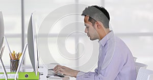 Asian businessman typing on computer keyboard.