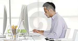 Asian businessman typing on keyboard.