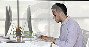 Asian businessman typing on keyboard.