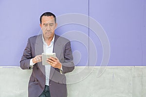 Asian Businessman use Digital Wireless Tablet Computer