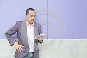 Asian Businessman use Digital Wireless Tablet Computer