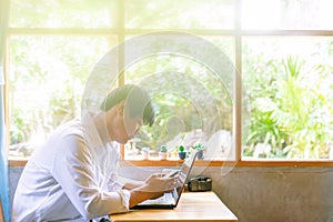 Asian businessman using the smartphone in a coffee shop