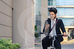 Asian businessman using their mobile phones to view applications, maps, directions to work in the morning