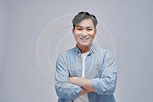 Asian businessman was crossing his arms and smiling confidently