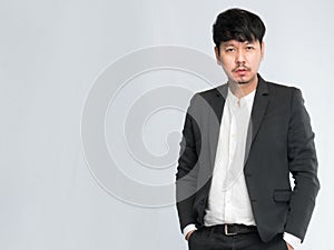 Asian businessman wear suits.standing and put the hand in the pant pocket