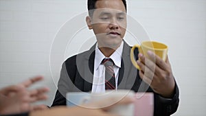 Asian businessman and woman meeting and select color ceramic mug