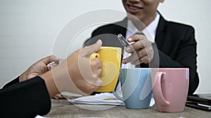 Asian businessman and woman meeting and select color ceramic mug