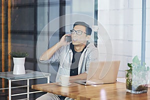 Asian businessman working on laptop in office alone