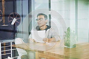 Asian businessman working on laptop in office alone