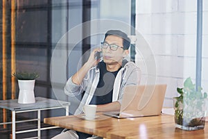 Asian businessman working on laptop in office alone