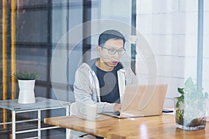 Asian businessman working on laptop in office alone