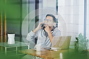 Asian businessman working on laptop in office alone