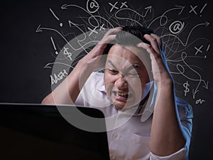 Asian Businessman Working on Laptop at the Office, Tired Stress Gesture