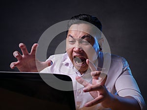 Asian Businessman Working on Laptop at the Office, Tired Stress Gesture