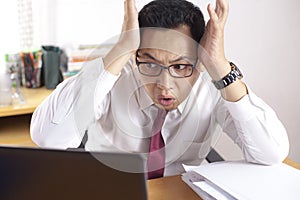 Asian Businessman Working on Laptop Shocked Stunned gesture