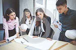 Asian businessmen and group using notebook for meeting and business women smiling happy for working