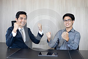 Asian businessmen Success and winning concept - happy team with raised up hands celebrating the breakthrough and achievements