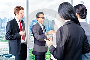Asian Businesspeople at flipchart