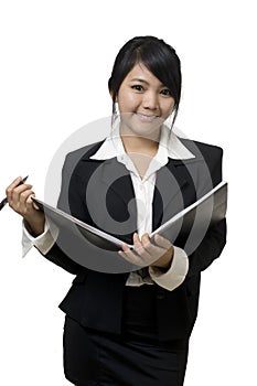 Asian businesswoman with book and pen