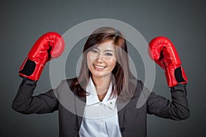 Asian businesswoman with boxing glove show her fists